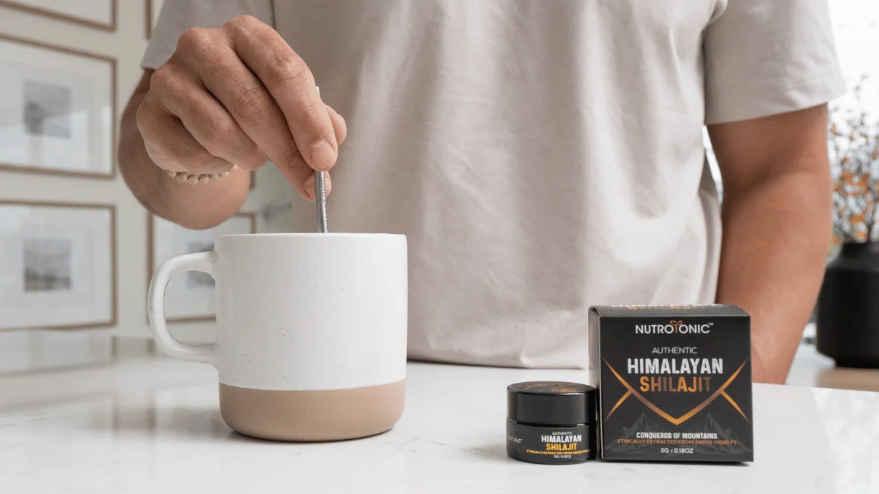 Walnut desk organizer set with white modular trays, next to porcelain mug on wooden desk.